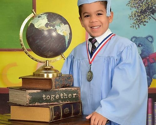   Young boy in graduation gown